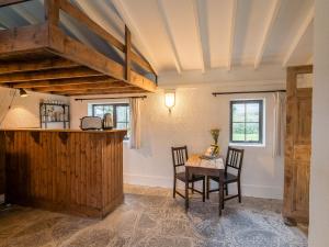 a dining room with a table and two chairs at Ventry Farm - The Parlour Cottage in Ventry