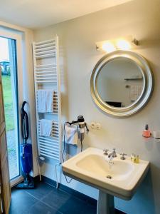 a bathroom with a sink and a mirror at Mansion Lake Starnberg in Feldafing
