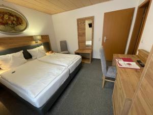 a hotel room with a bed and a desk and a desk at Pension "Am Brunnen" in Parchim
