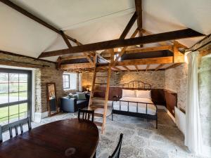 um quarto com uma cama e uma mesa num quarto em Ventry Farm - Rainbow Cottage em Ventry