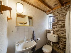 a bathroom with a sink and a toilet at Ventry Farm - Rainbow Cottage by Trident Holiday Homes in Ventry +28 photos