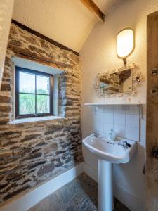 a bathroom with a sink and a window at Ventry Farm - Seaside Cottage in Ventry