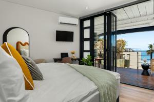 a bedroom with a bed and a view of the ocean at Neighbourgood 1st Crescent in Cape Town