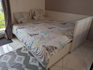 a bed with a quilt on it in a bedroom at Marvellous Disney Home 7 min from Disneyland in Magny-le-Hongre