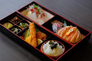 a box filled with different types of food on a table at ワタリグラスハウス in Gamō