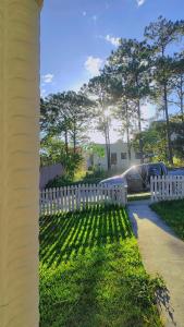 a white picket fence in front of a house at La casa de la Gaviota in Siguatepeque