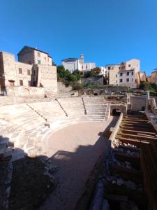 an amphitheater with steps and buildings in the background at Big Mama Jungle Rooms in Terracina