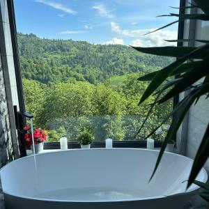 a bath tub with a view of a mountain at Forest Hub in Slavske