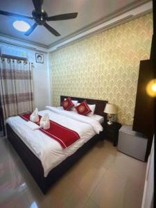 a bedroom with a large bed with red pillows at Xuan Keo place house 2 in Luang Prabang