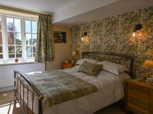 a bedroom with a bed and a large window at 2 Bed in Starnthwaite LCC35 in Crosthwaite