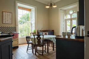 a kitchen with a table and chairs in a room at Kilfane Glebe House in Thomastown