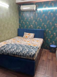 a bed in a room with a blue bed frame at OYO Hotel silver stone in Najafgarh