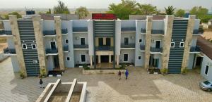 a building with people standing in front of it at Pula Pula Luxury Hotel and Suites in Karewa