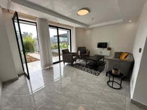 a living room with a couch and a table at Coalescence Hotel Rwanda in Kigali