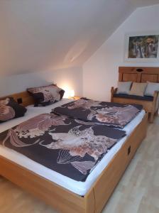 a bedroom with two beds and a couch in it at Haus Wiesengrund in Rauhenebrach