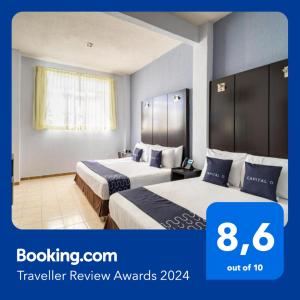 Habitación de hotel con 2 camas y paredes azules en Hotel Spa Shalam, en Coatepec