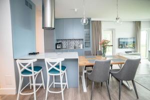 a kitchen with a table and chairs in a kitchen at Chill Nautica in Giżycko