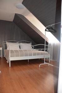 a white bed in a room with a ceiling at Largo apartment in the heart of Diocletian palace in Split