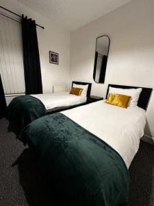 two beds in a hotel room withskirts at Anfield end terraced home in Liverpool