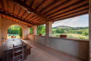 an outdoor patio with a table and a view at Villa degli Artisti by Mmega in Canonica +25 photos