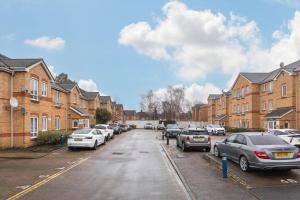 a street with parked cars in a residential neighbourhood at Spacious Stunning Flat near Heathrow and Central London in Hounslow