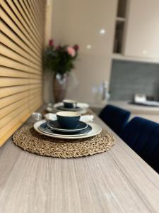 uma mesa com duas chávenas e pratos numa mesa em Large Cosy 2 bedroom Apartment in Stevenage SG1 Sleeps 5 em Stevenage