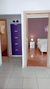 een slaapkamer met een paarse deur en een bed bij Relax in Preko