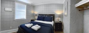 a bedroom with a bed with two towels on it at Amazing Cottage - Located on Blue Mile - Close to GSU! in Statesboro
