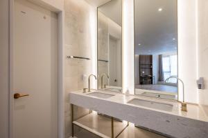 a bathroom with a sink and a mirror at Brown Dot Hotel Masan Yangduck in Changwon