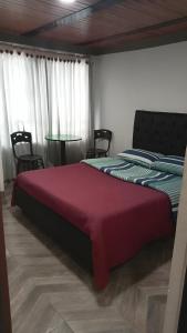 Katil atau katil-katil dalam bilik di HOTEL CASA BLANCA TUNJA