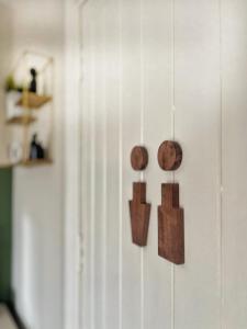 a wall with three wooden objects on it at The Starlings Country House in Wexford