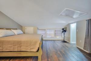 a bedroom with a bed and a window at Downtown Loft - Above Bull & Barrel & Close to Georgia Southern in Statesboro