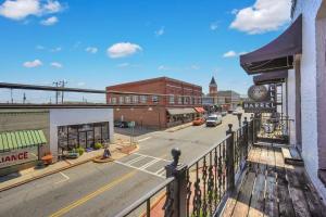 a view of a city street from a balcony at Downtown Loft - Above Bull & Barrel & Close to Georgia Southern in Statesboro