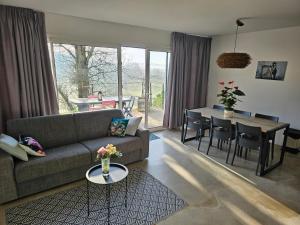 a living room with a couch and a table at Domaine de Massoulac in Molières