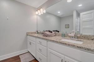 a bathroom with a sink and a large mirror at The Post Suite - above Bull & Barrel Close to GSU in Statesboro +21 photos