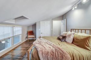 a bedroom with a large bed and a window at Eagle's Landing Loft-Downtown Above Bull & Barrel in Statesboro