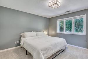 a bedroom with a white bed and a window at GATA 2 -The Rustic Suite - Close to GSU in Statesboro