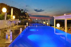 a swimming pool on the roof of a building at Hotel Rivage in Sorrento