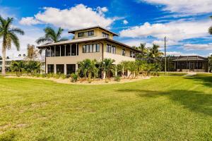 a large house with a lawn in front of it at Lostman's Lodge - Everglade City, Sunset View Pool & Hot Tub in Everglades City