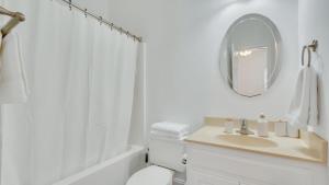a white bathroom with a sink and a mirror at Eagle's Retreat - Close to GSU & Paulson Stadium in Statesboro +16 photos