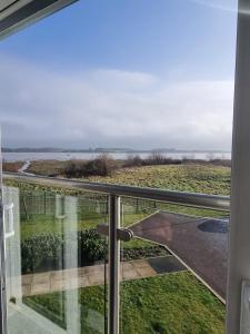 a view of the ocean from the balcony of a house at Estuary view in Fleetwood