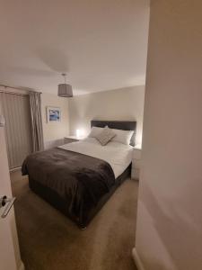 a bedroom with a large bed in a room at Estuary view in Fleetwood