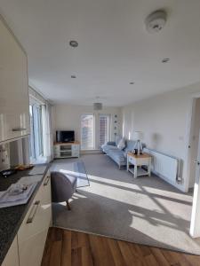 a living room with a couch and a table at Estuary view in Fleetwood