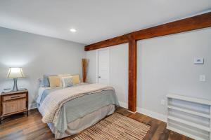 a bedroom with a bed and a sliding glass door at Eagle Exec Loft In Downtown Statesboro in Statesboro