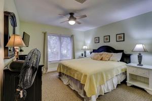 a bedroom with a bed and a ceiling fan at Fraser's Folly - Updated Harbour Town Villa in Hilton Head Island