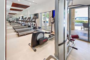 a row of treadmills in a gym with a row of machines at Silkhaus Burj Khalifa walking distance 1BDR in Downtown in Dubai