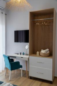 1 dormitorio con escritorio y silla azul en Memories Apartments en Sarandë