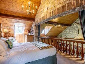 a bedroom with a large bed in a wooden room at 4 Bed in Dorchester 80513 in Charminster
