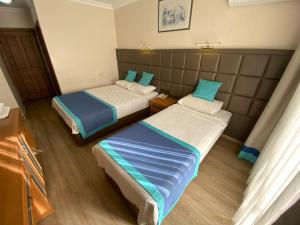 Postel nebo postele na pokoji v ubytování Prima Hotel