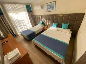 Postel nebo postele na pokoji v ubytování Prima Hotel